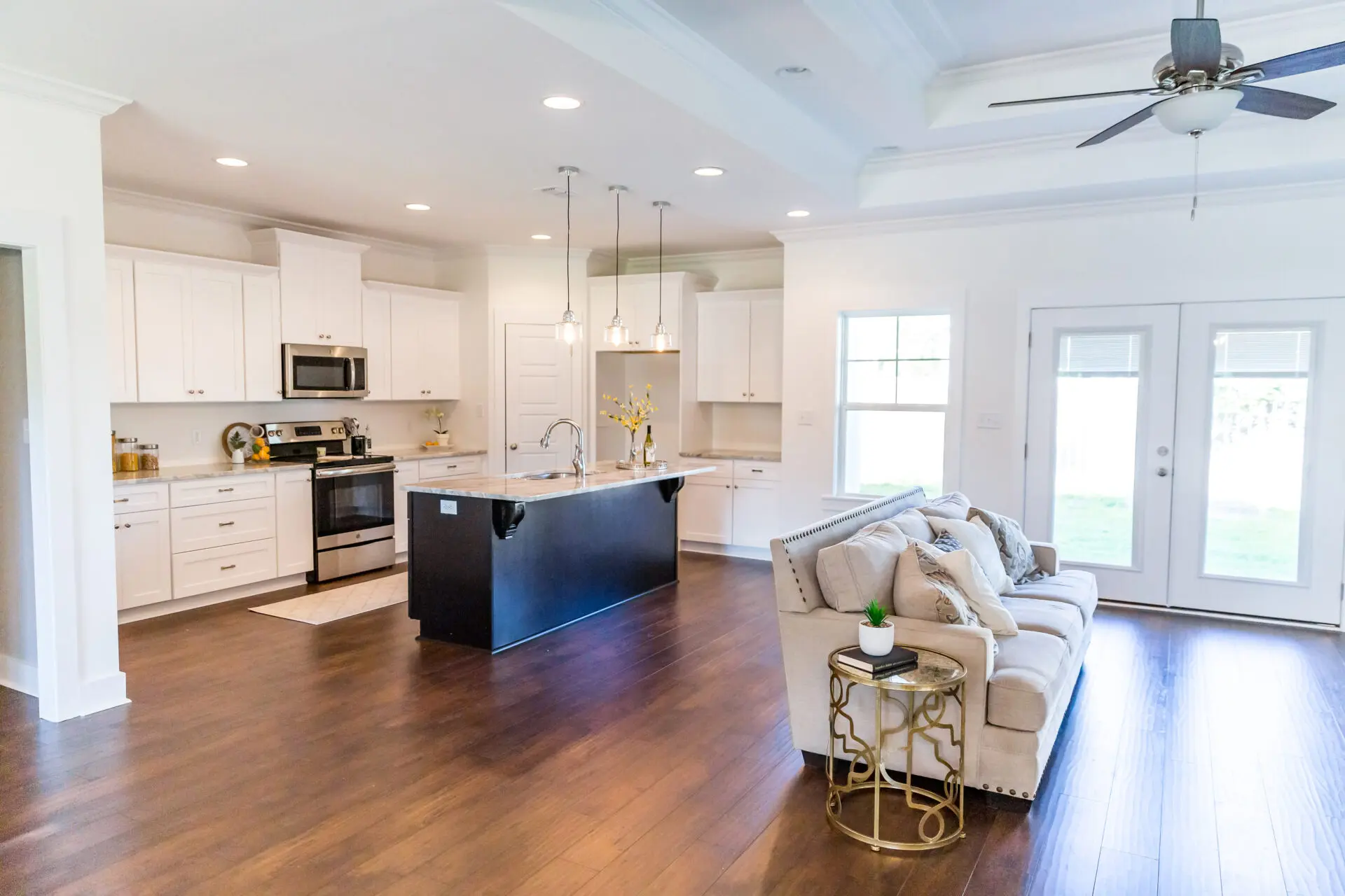 New construction modern kitchen with white cabinets and hardwood